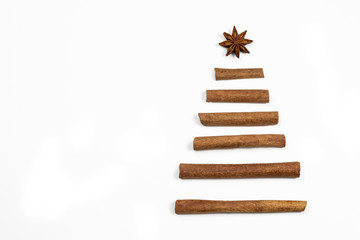  Christmas tree. Creative hand made Christmas tree concept. Anise and cinnamon stick spices Christmas tree shape on white background.