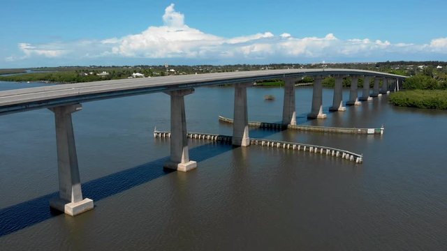 Aerial drone shot of displaying a causeway on the Indian River Lagoon in Sebastian FL. Shot of a Beautiful summer day on the water in Florida.