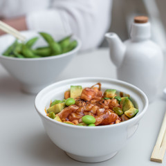 Chirashi Sushi Rice Bowl. Japanese Appetizer with Burnt Salmon, Edamame Soybeans, Avocado and Rice