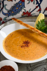 Turkish Red Lentil, Rice and Bulgur Soup Garnished with Lemon Wedge, Ezogelin Corbasi.