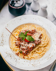 spaghetti with meat sauce and grated parmesan