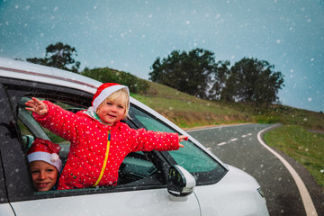 christmas car travel- happy girl and boy travel in winter