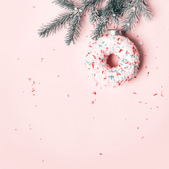 Christmas creative concept with ball made of donut on pink background, copy space
