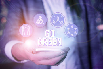Conceptual hand writing showing Go Green. Concept meaning making more environmentally friendly...