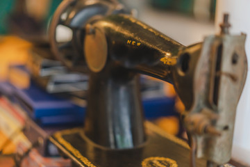 Fototapeta premium Measuring tape and old sewing machine on tailor table.