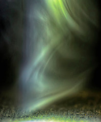 Abstract smoke shapes and green, black background