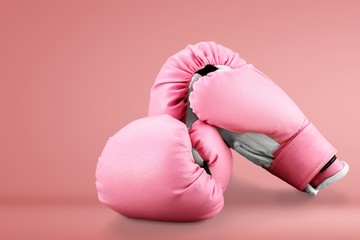 Pink boxing gloves on wooden desk