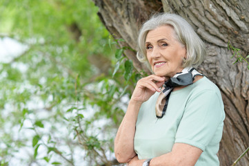 Portrait of happy senior woman smiling in park