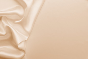 Beautiful smooth elegant wavy beige / light brown satin silk luxury cloth fabric texture, abstract background design. Copy space. Card or banner