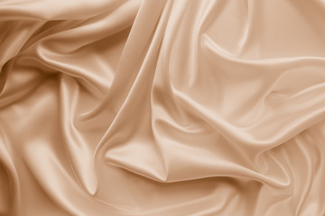 Beautiful smooth elegant wavy beige / light brown satin silk luxury cloth fabric texture, abstract...