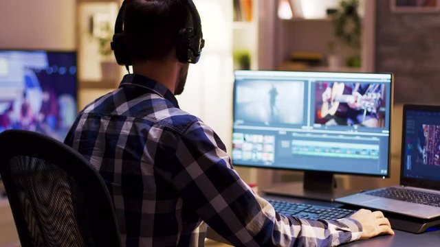Young videographer with headphones using modern software