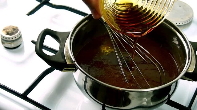Pouring golden syrup into melted chocolate