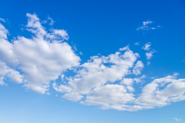 Blue sky with close up white fluffy tiny clouds background and pattern