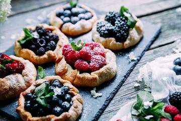 biscuit with berries of blackberry, raspberry, blueberry, black currant, strawberry