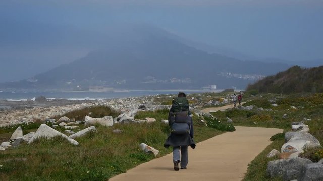 pilgrim goes along the trail along the ocean