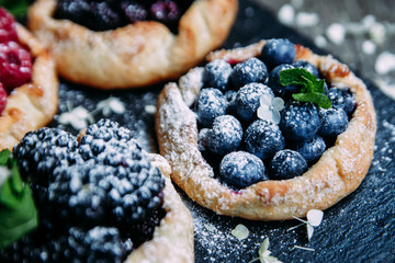 biscuit with berries of blackberry, raspberry, blueberry, black currant, strawberry