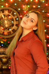 Portrait of young woman posing in room decorated to Christmas holiday