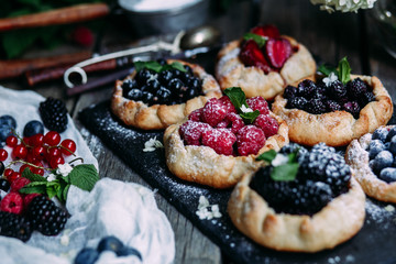biscuit with berries of blackberry, raspberry, blueberry, black currant, strawberry