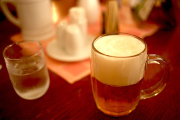 beer mug on a wooden table stands in a pub