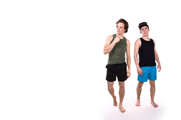 Obraz premium Fitness and healthy lifestyle. Two funny young guys. White background.