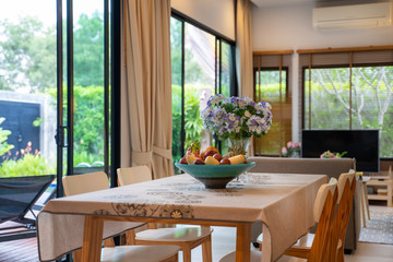 Dining area with pool view and fruits basket
