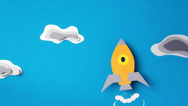 Lightning strikes rocket flying through clouds, stop motion animation. Paper art. Business start up concept. Сoncept of overcoming obstacles.