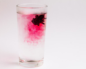 glass with water and hibiscus flower