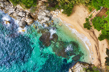 Sea Aerial view. Top view, nature background. Azure sea beach with rocky mountains and clear water at sunny day. Flying drone. Tropical trees. - 306196679