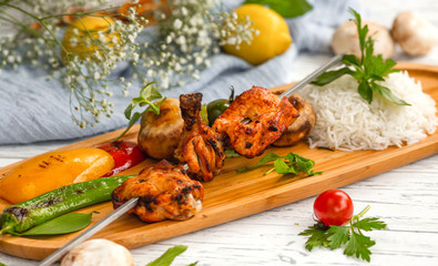 skewered chicken kebab with rice and vegetables