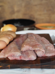 pike fish fillet on a cutting board with ingredients for cooking