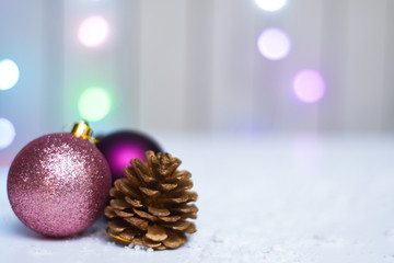 Festive christmas decorations with glowing lights in background on snow