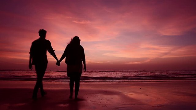 Couples walking in beach at sunset, HD video