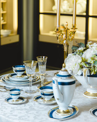beautiful dish set and gilded candlesticks