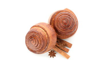 Freshly baked cinnamon roll with ingredients isolated on white background. Top view