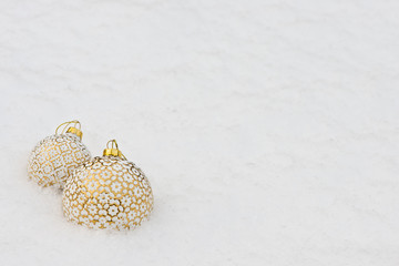Christmas background with golden balls on snow (selective focus)/ Merry Christmas/ Happy New Year