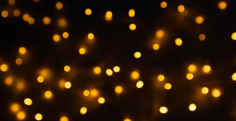 abstract golden bokeh light festive holiday on black background