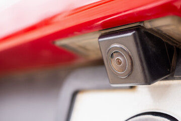 Red car rear view camera close up for parking assistance