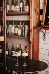 Two gin based sorbet cocktails on a silver table. Concept of refreshing cocktails and alcoholic drinks. Selective focus on the glasses.