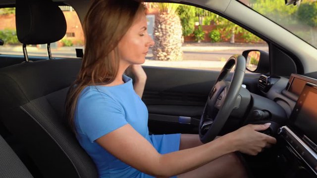 Woman in blue dress is angry and upset, because her car broke down