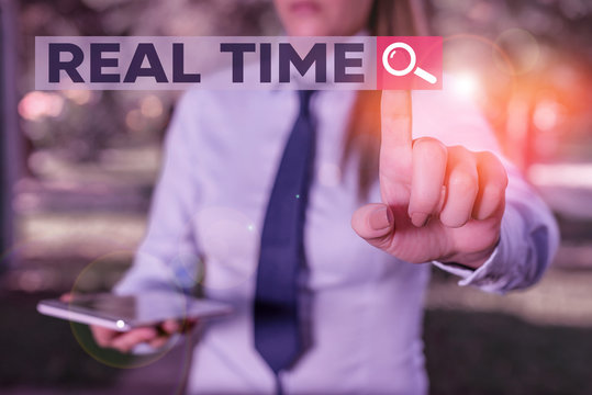 Word writing text Real Time. Business photo showcasing the actual time during which a processes or events occurs Handsome business girl pointing with finger into empty space