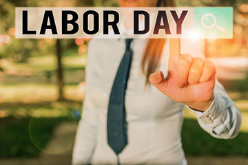Writing note showing Labor Day. Business concept for an annual holiday to celebrate the achievements of workers Handsome business girl pointing with finger into empty space