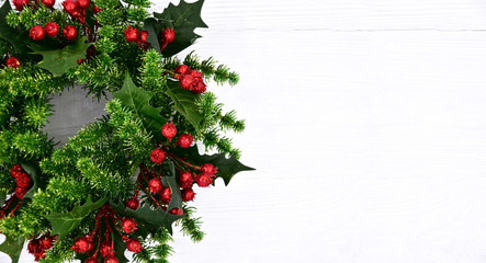 Fototapeta na wymiar Christmas wreath on a white wooden background. Close-up. Christmas background.