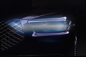 Fototapeta na wymiar Detail on one of the LED headlights modern car on black background