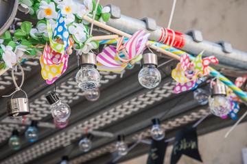Scaffolding Covered in coloured ribbon, vintage decoration greens pink blue red yellow orange floristry metal wires retro style polka dot ribbons white petals on the wall indie