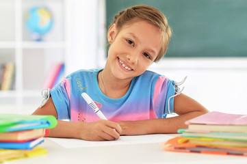 Portrait of cute little girl drawing at home