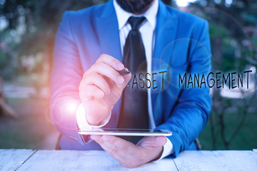 Writing note showing Asset Management. Business concept for analysisaged investment of assets of a...