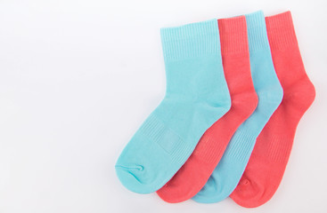 pink and blue socks on a white background.