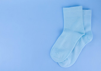 Blue socks on a blue background. Socks on a colored background
