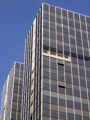 Brussels, Belgium, 10/07/2019 Old unkept sky scraper poorly maintained European office building with blue skies and rusty, dirty windows in the main business district of Brussels