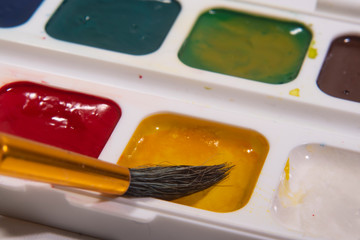 Yellow watercolor paint brush